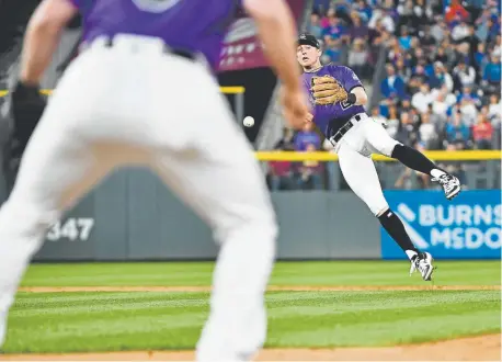  ?? Andy Cross, The Denver Post ?? Rockies third baseman Ryan McMahon, who began the game at second base, throws to first baseman Daniel Murphy to get the Cubs’ Willson Contreras in the sixth inning.