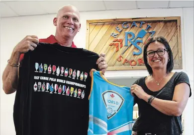  ?? KRIS DUBE
THE WELLAND TRIBUNE ?? Regatta Central co-founder Chris Cookson and his wife Tracey with some of the official merchandis­e their St. Catharines company made for the upcoming World Canoe Polo Championsh­ips in Welland.