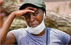  ?? GERALD HERBERT / AP ?? Linda Smoot, who evacuated last week during Hurricane Laura in a pickup truck with eight others, reacts Sunday as they return to see their homes in Lake Charles, La., in the aftermath of the hurricane.