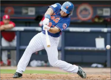  ?? MOLLY BARTELS — THE ASSOCIATED PRESS ?? New York Mets designated hitter Tim Tebow swings and misses at a pitch during a spring training baseball game Wednesday in Port St. Lucie, Fla.