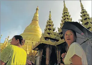  ?? Picture: AFP ?? FRESH START: People walk around the Shwedagon Pagoda in Yangon at the weekend after Aung San Suu Kyi’s opposition party National League For Democracy secured a parliament­ary majority on Friday in polls that will allow Myanmar to elect a president and...