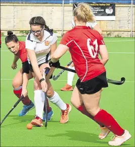  ?? Picture: Ken Mears FM31028011 ?? Right, Ashford ladies’
2nds under pressure from Gravesend 1sts (red). The Kent Division 1 game ended in a 4-4 draw