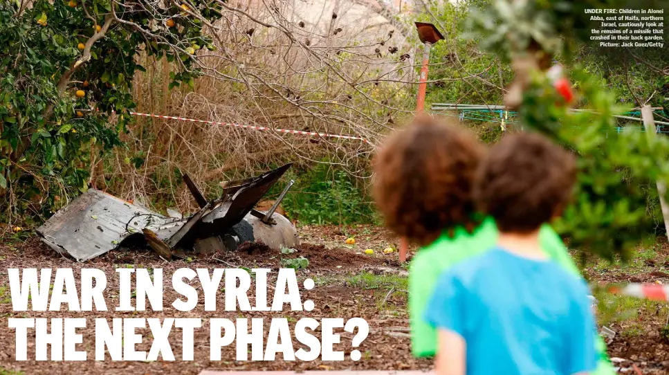  ?? Picture: Jack Guez/Getty ?? UNDER FIRE: Children in Alonei Abba, east of Haifa, northern Israel, cautiously look at the remains of a missile that crashed in their back garden.