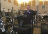  ?? ZACHARY SRNIS — THE MORNING JOURNAL ?? Andy Dito, personal trainer at Lorain County Community College, shows off an elliptical at Ewing Fitness and Education Center.