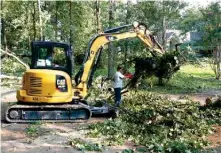  ?? The Sentinel-Record/Richard Rasmussen ?? ■ Garland County employees work on removing downed trees on Windy Point Thursday.