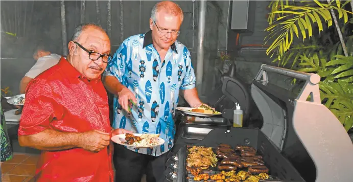  ??  ?? Papua New Guinea’s prime minister Peter O’Neill and Scott Morrison during a barbecue at the end of the summit in Port Moresby last weekend.