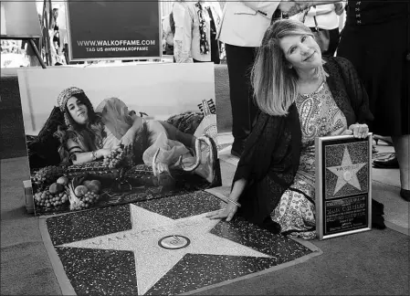  ?? CHRIS PIZZELLO / ASSOCIATED PRESS FILE (2022) ?? Owen Elliot-kugell, daughter of the late singer “Mama” Cass Elliot (pictured at left), poses alongside Cass Elliot’s star on the Hollywood Walk of Fame after a ceremony Oct. 3, 2022, in Los Angeles. Elliott-kugell’s new book, “My Mama, Cass,” was released Tuesday.