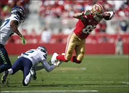  ?? NHAT V. MEYER — BAY AREA NEWS GROUP, FILE ?? The 49ers’ George Kittle (85) dodges a tackle by the Seahawks’ D.J. Reed (2) in the second quarter at Levi’s Stadium on Oct. 3in Santa Clara.