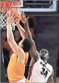  ?? Joshua L. Jones / AP ?? Tennessee’s Grant Williams (left) has his shot blocked by Georgia’s Derek Ogbeide during Saturday’s game.