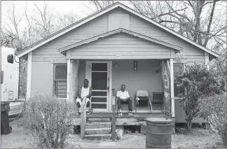  ??  ?? Gregory Barnes, left, sits with his uncle, Herbert Barnes, on the front porch of their rental home in Acres Homes in Houston.