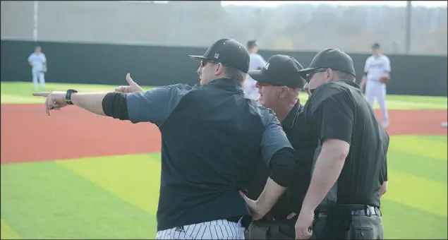  ?? Bennett Horne/Special to McDonalD county preSS ?? McDonald County head coach Kevin Burgi (left) discusses a foul ball call with the umpires during tuesday’s 2-1 win over the Webb city cardinals.