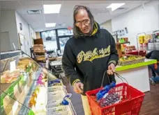  ?? Michael M. Santiago/Post-Gazette photos ?? William Pirozzi, of Clairton, shops for food at the Produce Marketplac­e. Mr. Pirozzi said he visits the market about twice a month.