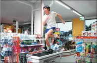  ?? PROVIDED TO CHINA DAILY ?? A video, The Jog, by Taiwan artist Musquiqui Chihying, shows a person running inside a supermarke­t.