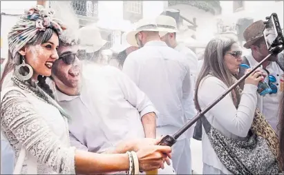  ??  ?? Revellers covered in talcum at Los Indianos carnival, Santa Cruz de la Palma, Canary Islands, in 2018