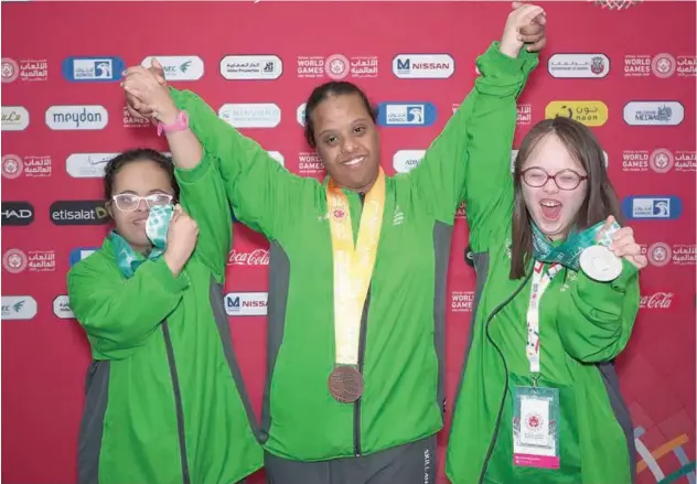  ??  ?? ↑ Saudi Arabia’s Jana Albeshri , Shahad Sunbul and Sara Felemban celebrate with their medals.