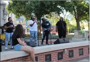  ?? LYRIC AQUINO — THE MORNING JOURNAL ?? A live musical act plays in Ely Square as part of the first Third Thursday in Elyria on June 17.