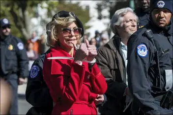  ?? MANUEL BALCE CENETA — THE ASSOCIATED PRESS ?? Actress Jane Fonda gestures after being arrested during a rally on Capitol Hill in Washington, Friday. A half-century after throwing her attention-getting celebrity status into Vietnam War protests, Fonda is now doing the same in a U.S. climate movement where the average age is 18.