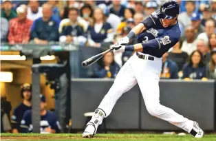  ?? JEFF ROBERSON/ASSOCIATED PRESS ?? The Brewers’ Christian Yelich hits a two-run home run during the third inning of Game 1 of the National League Division Series against the Colorado Rockies.