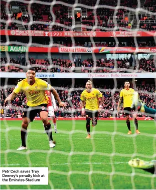  ??  ?? Petr Cech saves Troy Deeney’s penalty kick at the Emirates Stadium