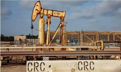  ?? Universal Images Group/Getty Images ?? Old oil wells and pump jacks in Huntington Beach, California, in an undated photo. Photograph: Education Images/Citizen of the Planet/