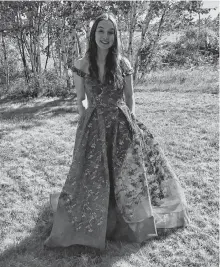  ?? CAPE BRETON POST NICOLE SULLIVAN • ?? Riverview High School graduate Laura Colford stands in the backyard of her South Bar home, wearing her prom dress which she's not sure she'll get to wear due to pandemic health protection measures in Nova Scotia.