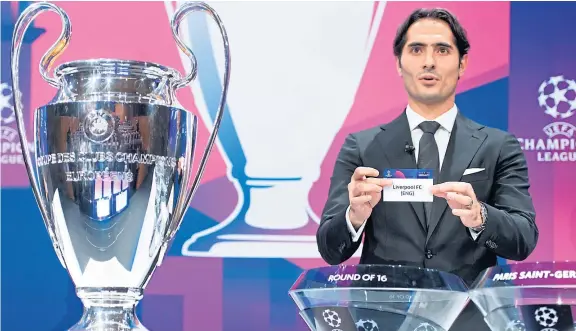  ?? AP. ?? Turkish player Hamit Altintop shows Liverpool’s ticket while making the Champions League last-16 draw at Uefa headquarte­rs in Nyon.