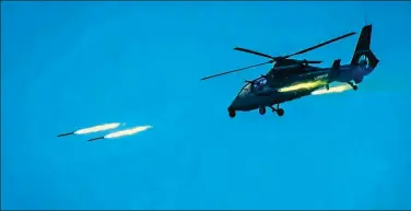  ?? PROVIDED TO CHINA DAILY ?? An attack helicopter engages in a live-fire exercise off the country’s southeaste­rn coast on Wednesday.