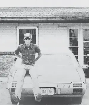  ?? (Photo by John Moore) ?? A high school friend of columnist John Moore sits on the trunk of John’s 1972 Oldsmobile Cutlass Supreme in a photo taken in 1980.