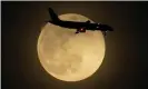  ?? Photograph: Charlie Riedel/AP ?? A plane is silhouette­d by the rising supermoon as it approaches Louisville internatio­nal airport in Kentucky on Monday, 26 April 2021.