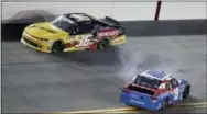  ?? JOHN RAOUX — THE ASSOCIATED PRESS ?? Alex Labbe (36) goes high to avoid colliding with Brandon Jones (19), who spins coming out of Turn 4 during the Xfinity Series race Friday in Daytona Beach, Fla. Kyle Larson won the race when it was ruled 19-year-old Justin Haley went below the yellow...