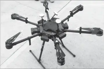  ?? ASSOCIATED PRESS ?? THIS UNDATED PHOTO PROVIDED BY THE U.S. BORDER PATROL shows a 2-foot-high drone that a border patrol agent spotted swooping over the border fence on Aug. 8, near a San Diego border crossing. Authoritie­s have arrested a man they say used the drone to...