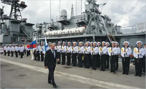  ??  ?? Russian President Vladimir Putin attends a welcoming ceremony as he inspects an anti-submarine ship in Novorossiy­sk in 2014