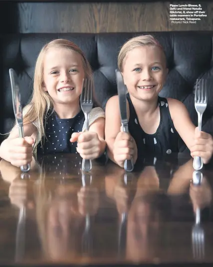  ?? Picture / Nick Reed ?? Pippa Lynch- Blosse, 8, ( left) and friend Natalia Gilchrist, 8, show off their table manners in Portofino restaurant, Takapuna.