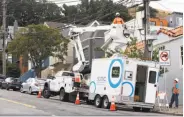  ?? Paul Chinn / The Chronicle ?? Carlos Contreras (in basket) and Josh Bishop install equipment for Sonic’s gigabit service in S.F. in June.