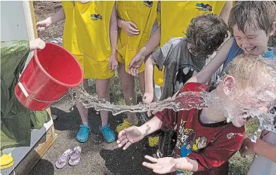  ?? CLIFFORD SKARSTEDT EXAMINER FILE PHOTO ?? Kids cool off at the Lather Up station during the 2017 Peterborou­gh Water Children's Festival at the Riverview Park and Zoo.