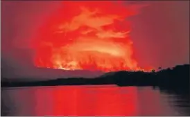  ??  ?? Smoke and flames are seen at the Nyiragongo volcanic eruption from the Tchegera Island on Lake Kivu, near Goma, in the Democratic Republic of Congo on Saturday.