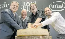  ?? FABRICE COFFRINI/GETTY IMAGES ?? From left, Tag Heuer’s Guy Semon and Jean-Claude Biver, Intel’s Michael Bell and Google’s David Singleton pose with Swiss cheese Thursday during an announceme­nt of a partnershi­p among the three companies.