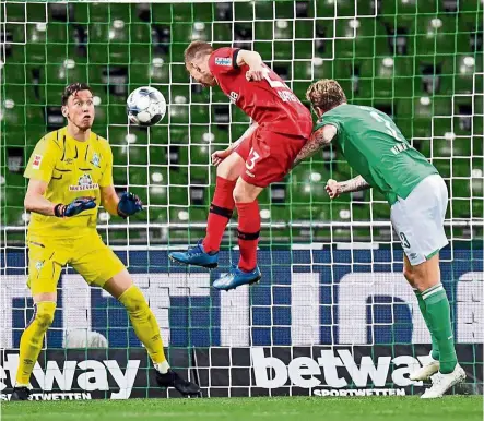  ?? — reuters ?? Bang on target: Bayer Leverkusen’s Mitchell Weiser scoring the third goal against Werder Bremen in the Bundesliga match on Monday. Bundesliga became the first top European league to resume the season.