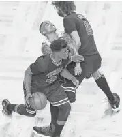  ?? Charles Krupa / Associated Press ?? The Celtics’ Isaiah Thomas, center, gets caught in a squeeze play between a driving Jimmy Butler, left, and a screening Robin Lopez.