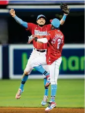  ?? DANIEL A. VARELA dvarela@miamiheral­d.com ?? Marlins shortstop Miguel Rojas celebrates with Jazz Chisholm Jr. after beating the Phillies on Sept. 4.