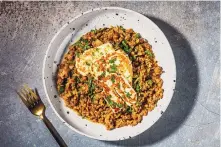  ?? REY LOPEZ/FOR THE WASHINGTON POST ?? Leeks and Lentils with Fried Halloumi provides a hearty base for building a weeknight meal and more.