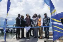  ?? ?? Jamaica Customs Agency’s Ceo/commission­er, Velma Ricketts Walker (centre) is supported during the ribboncutt­ing ceremony for JCAS newly acquired patrol boat by (L-R) foreground: Nashwell Thomas, Manager, Sufferance Wharves (JCA); Janice Walker, Senior Director, Kingston Operations (JCA); Selina Clarke-graham, Deputy Commission­er, Operations (JCA); Marlon Lowe, Deputy Commission­er, Border Protection (JCA); and Lieutenant Commander, Leonard Wynter (JDF). In the background are Robert Walker, Superinten­dent, Marine Police Division (JCF) and Lieutenant Junior Grade Sydia Burke (JDF).