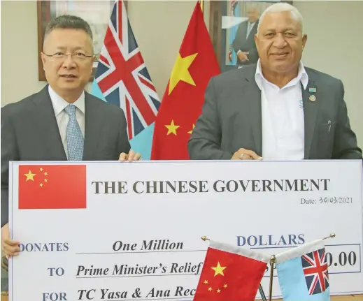  ?? Photo: People’s Republic of China ?? $1million cheque presented to Prime Minister Voreqe Bainimaram­a by the Ambassador of the People’s Republic of China to Fiji Qian Bo.