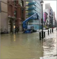  ?? PATRICIA MADEJ/THE PHILADELPH­IA INQUIRER VIA AP ?? Water covers a street after a water main broke in Philadelph­ia on Tuesday morning.