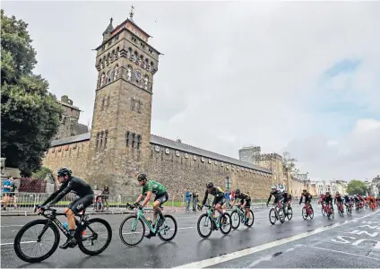  ??  ?? Flying Dutchman: Lars Boom (second left) passes Cardiff Castle on his way to taking overall victory in the Tour of Britain