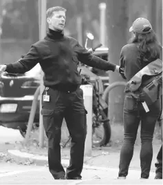  ??  ?? A police officer closes a street as 60,000 people in Frankfurt are about to evacuate the city. — Reuters photo