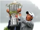  ?? AP PHOTO/JEFF CHIU ?? Collin Morikawa reacts as the top of the Wanamaker Trophy falls after he won the PGA Championsh­ip on Sunday at TPC Harding Park in San Francisco.