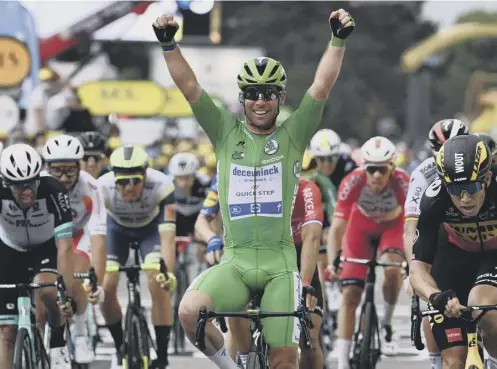  ??  ?? 0 Mark Cavendish raises his hands in triumph at the end of yesterday’s 10th stage of the Tour de France in Valence