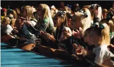  ??  ?? Performers cheer on other performers during the competitio­n Saturday.