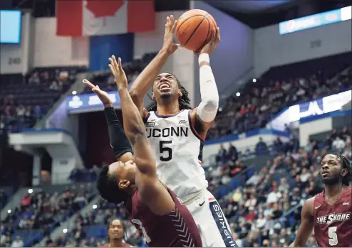  ?? Jessica Hill / Associated Press ?? UConn’s Isaiah Whaley, right, shoots over Maryland-Eastern Shore’s Donchevell Nugent in the first half of a game on Nov. 30 in Hartford.